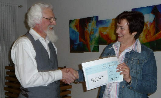 Thekla Braun presents to Franz X. Koehler check about 6000 Euro for the refurbishment of the Organ.   Photo: private